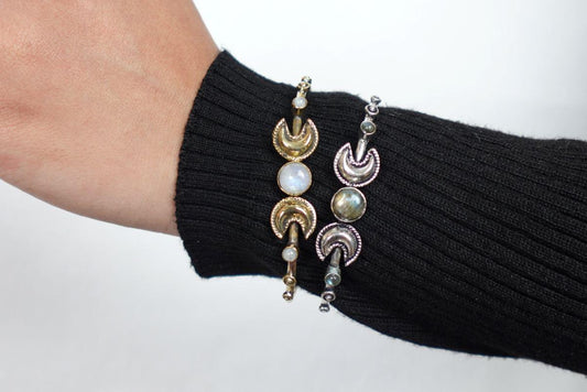 Double Moonstone Lunar Cuff Bracelet - Brass and silver cuffs with crescent moons and moonstones—mystical and chic.