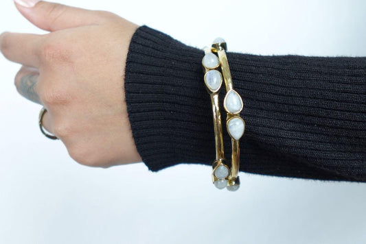 Teardrop Moonstone Brass Cuff - Sleek gold-tone brass cuff with teardrop moonstones in minimalist design.