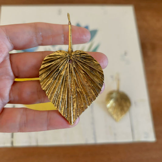 Close-up of pleated leaf veins on Textured Brass Leaf Statement Earrings — Sacred Grove, held in hand for scale