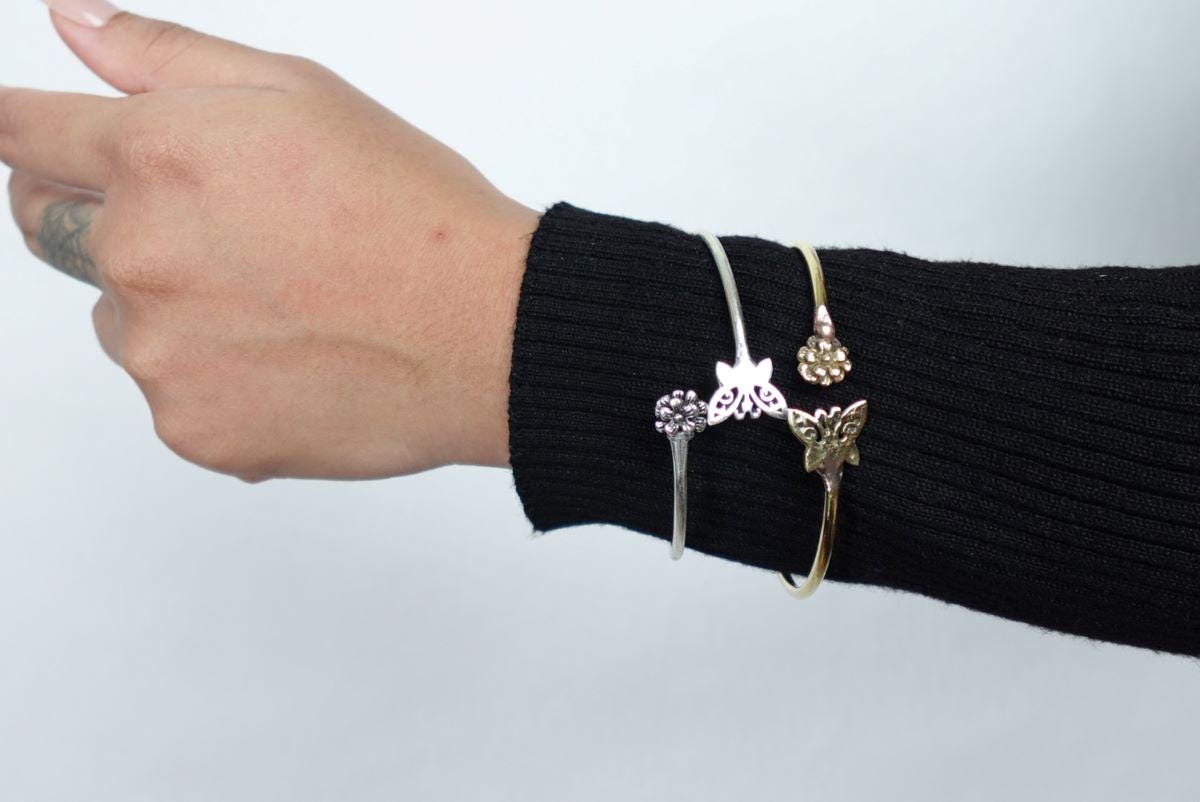 Whimsical Butterfly Open Bangles - Adjustable bangles featuring butterfly and flower motifs in brass and silver.