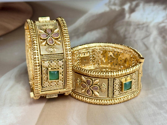 Emerald Bloom Rajwadi Kada - Gold polished bridal kada with floral pastel petal motifs and green square stones in embossed temple styling..
