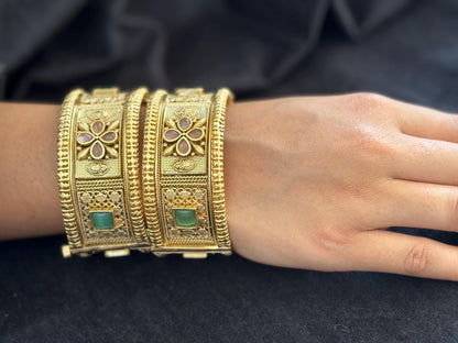 Emerald Bloom Rajwadi Kada - Gold polished bridal kada with floral pastel petal motifs and green square stones in embossed temple styling..