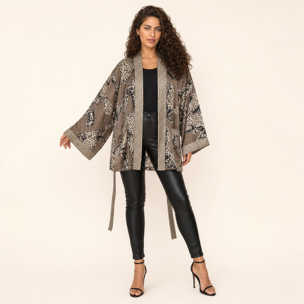 Woman in Leopard Print Satin Kimono — Untamed Earth styled open over dark outfit
