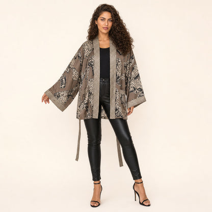 Woman in Leopard Print Satin Kimono — Untamed Earth styled open over dark outfit