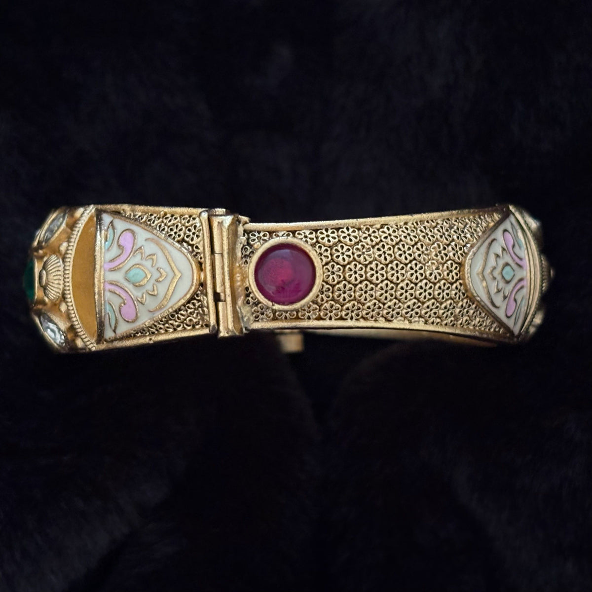 Close-up of crimson glass cabochon and screw-pin hinge on Kundan Meenakari Brass Kada Bangle
